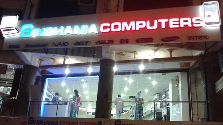 Singhania Computers multi-brand showroom in Surat, lit up at night